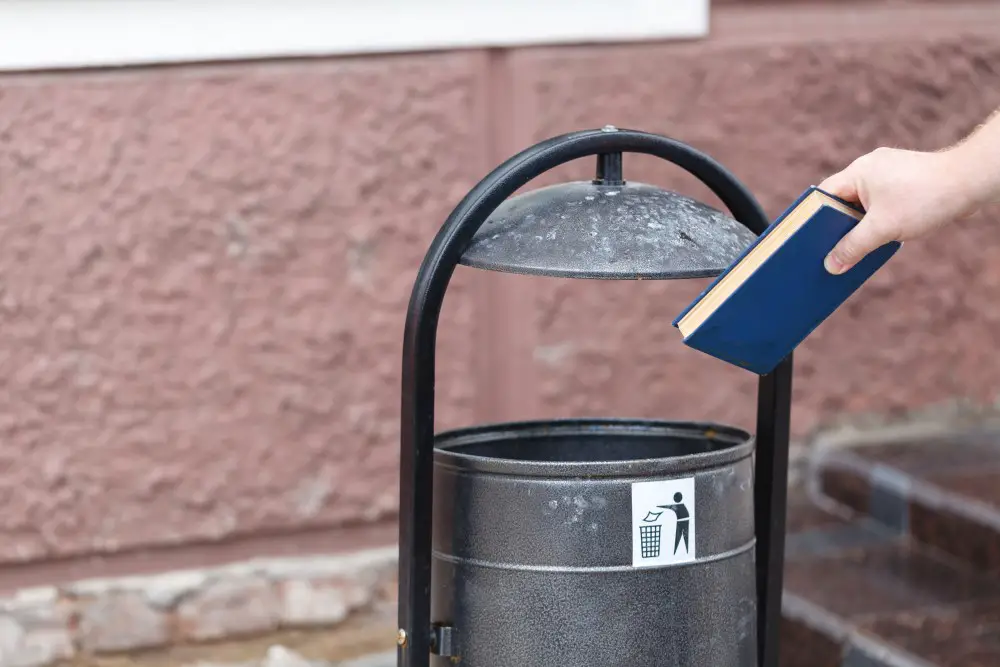 book being throw into trashcan